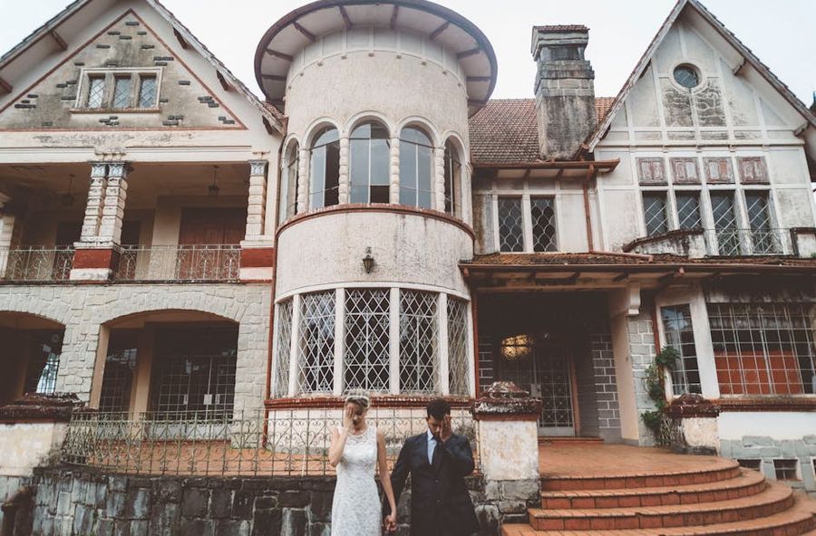 Historic House Portrait Wedding couple standing outside a large historic house