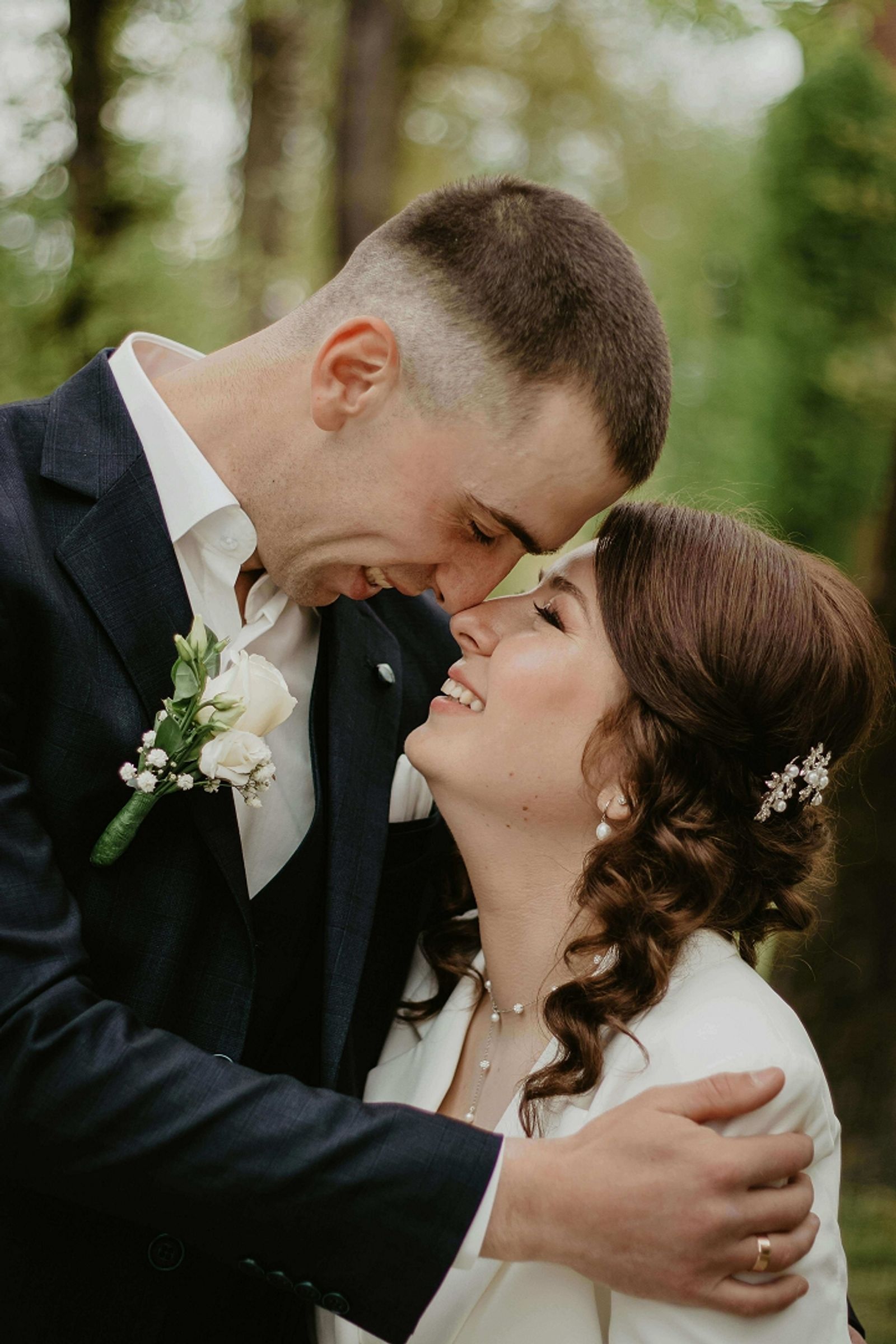 Close wedding couple portrait with foreheads touching