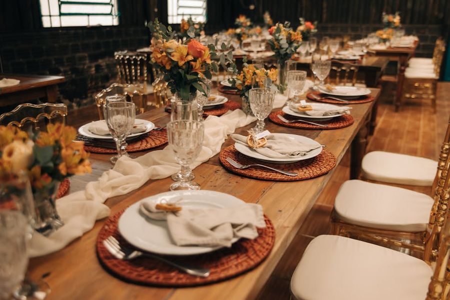 Rustic Reception Tables Rustic reception tables with orange flowers and woven placemats
