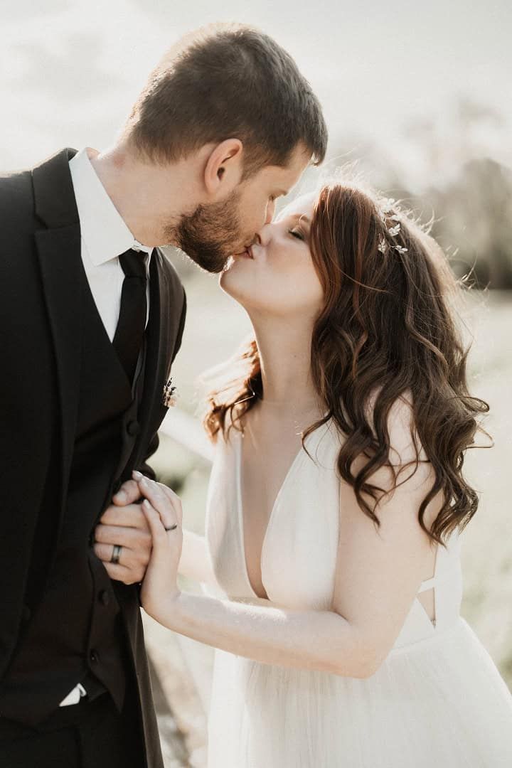 Close Kiss Wedding couple kissing in a close vertical portrait