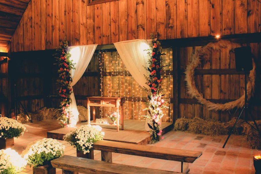 Barn Ceremony Backdrop Draped ceremony backdrop inside a wooden barn