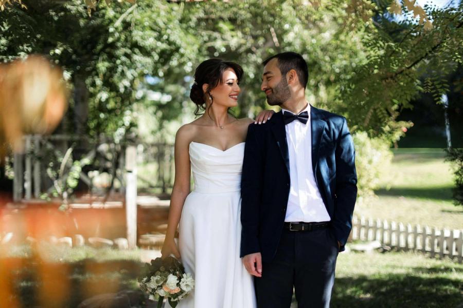 Leafy Tree Portrait Wedding couple standing together beneath leafy trees