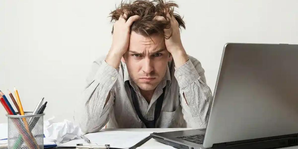 Frustrated business owner at laptop dealing with website technical SEO issues