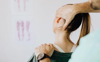 Woman getting her neck assessed for neck pain treatment with chiropractic and physiotherapy in Mesa, AZ