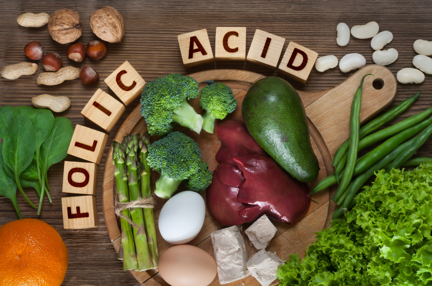 "Folic Acid" spelled out in block letters surrounded by foods high in folic acid.