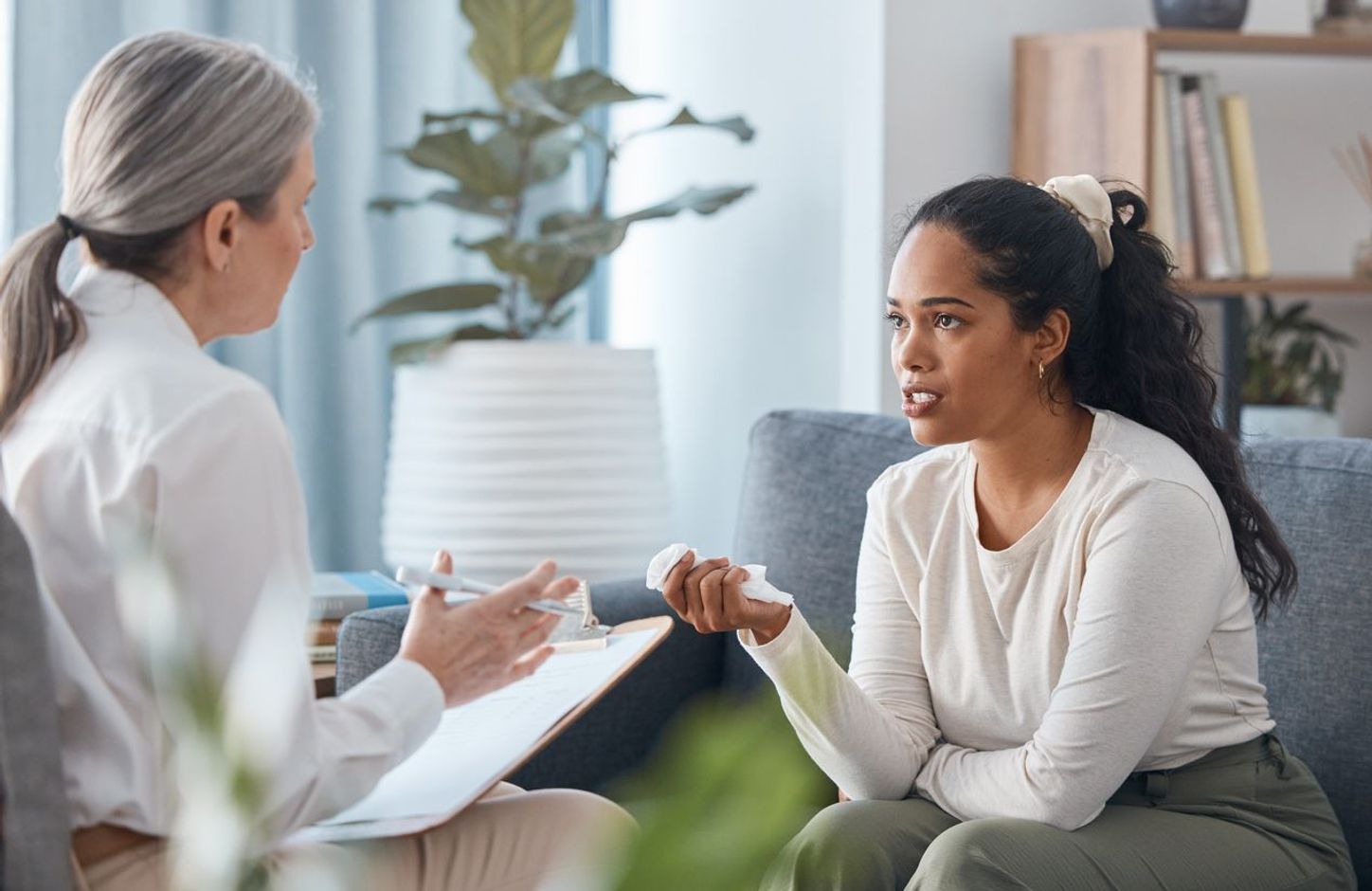 A person holding a tissue is unhappy with their care provider.
