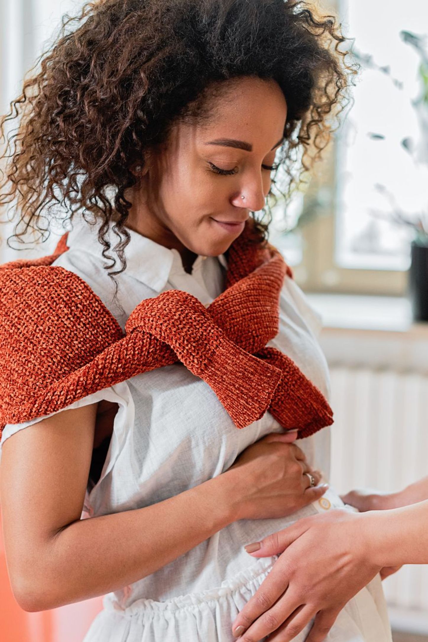 A parent holding their baby against their chest