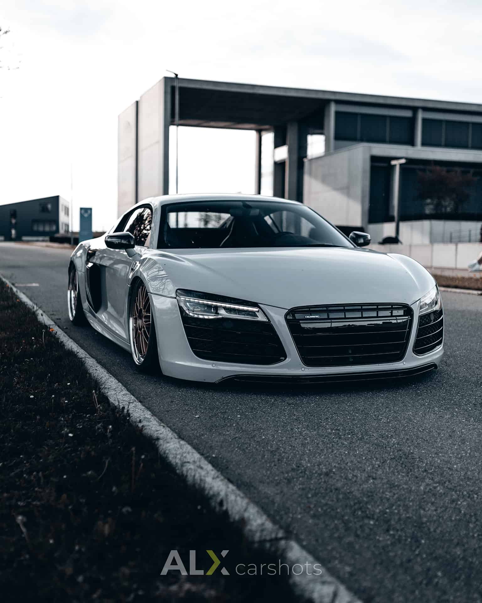 Weißer Audi R8 vor moderner Beton- und Glasarchitektur in einem Gewerbepark am Bodensee