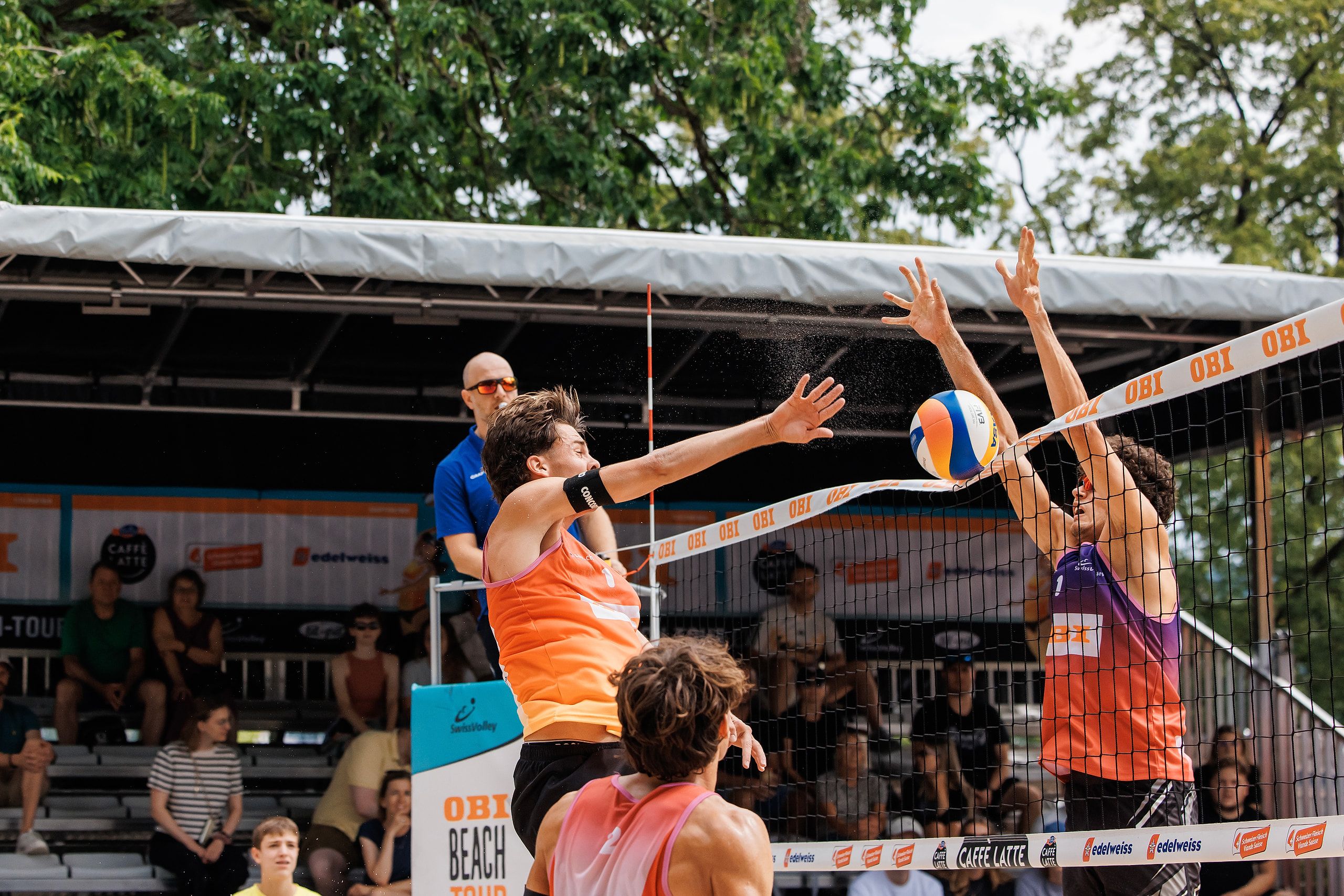 Daniel Allemann im Angriff gegen den Block von Maël Masserey, im Spiel Allemann/Leffler gegen Masserey/Schnegg bei der OBI Beach Tour 2026 in Luzern.