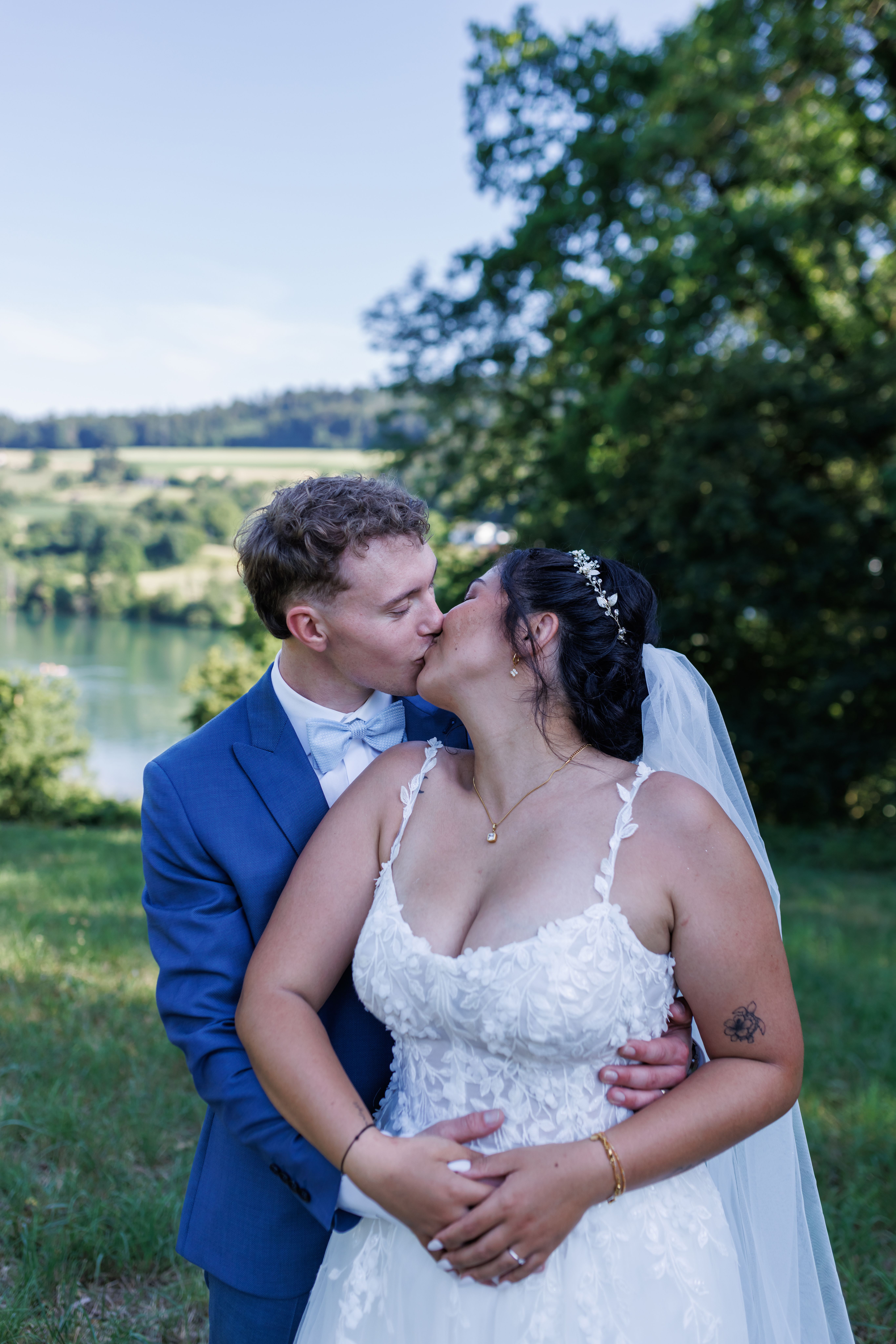 Stefanie und Manuel küssen sich vor der Kulisse des Sees
