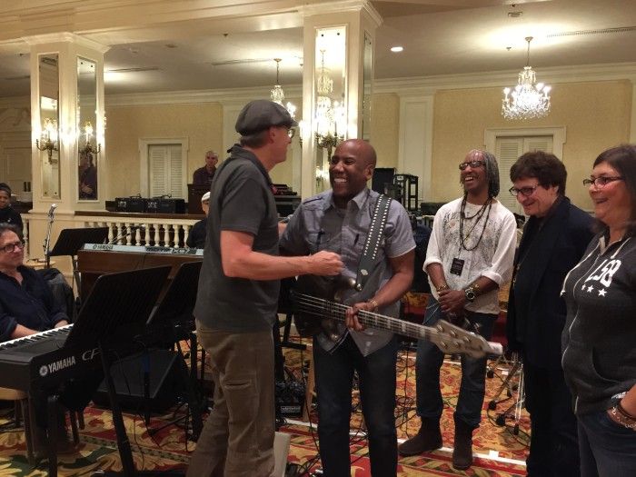 James greets bassist Nathan East. Photo by Ellyn Kusmin.