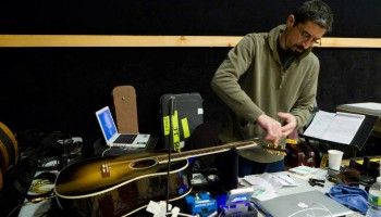 JP re-stringing a guitar. (Photo: Michael Lutch)