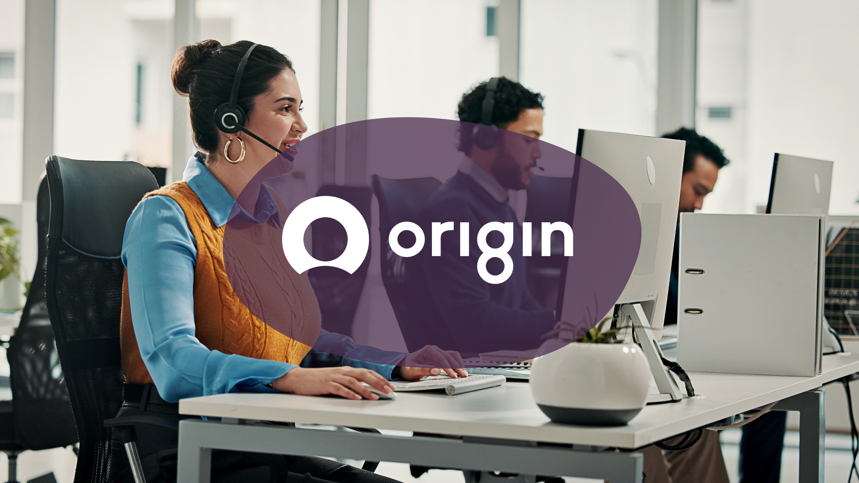 A smiling call center agent wearing a headset at a desk, with the Origin logo overlaid on the image.