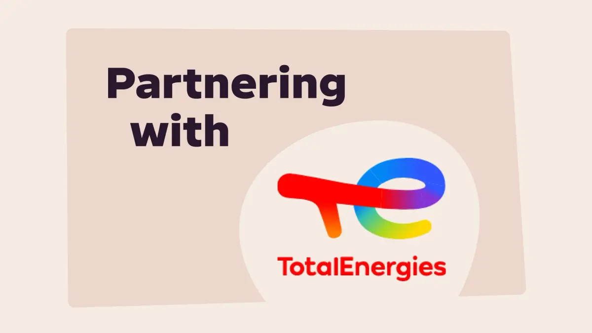 Text reads "Partnering with" next to the TotalEnergies logo, which is a stylized rainbow "te" with "TotalEnergies" written below.