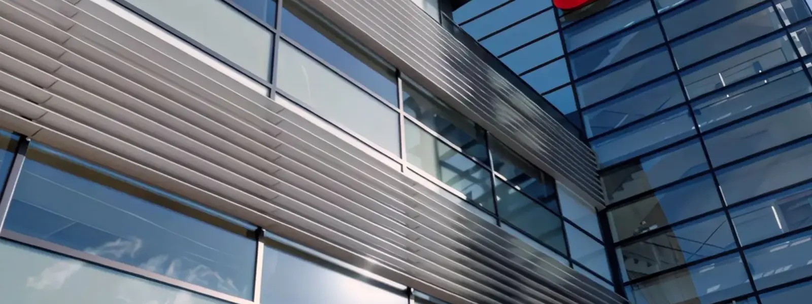 A modern office building with glass walls and the red 'e.on' logo.