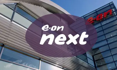 Modern building with the red "e-on" logo on its facade, overlaid with a purple oval containing the white text "e-on next".