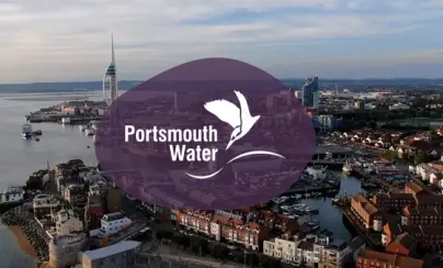 Aerial view of Portsmouth with Spinnaker Tower and Portsmouth Water logo.