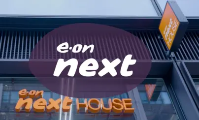 "e.on next HOUSE" signage on a building exterior with an "e.on next" logo overlay.