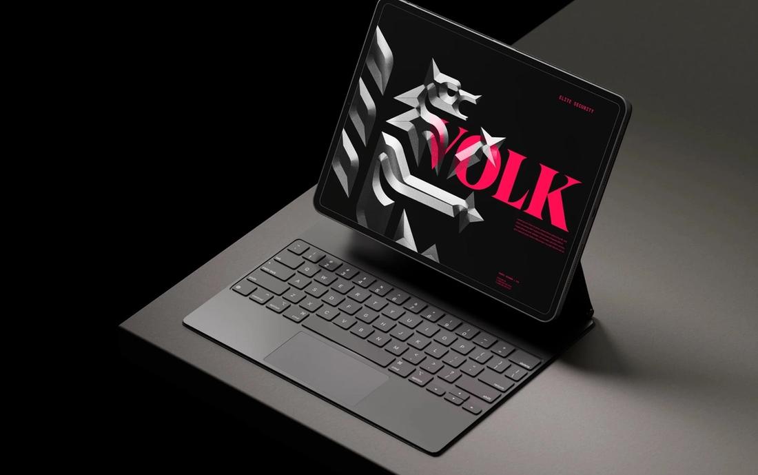 Identidad de Volk en una tableta: lobo tridimensional y logotipo magenta