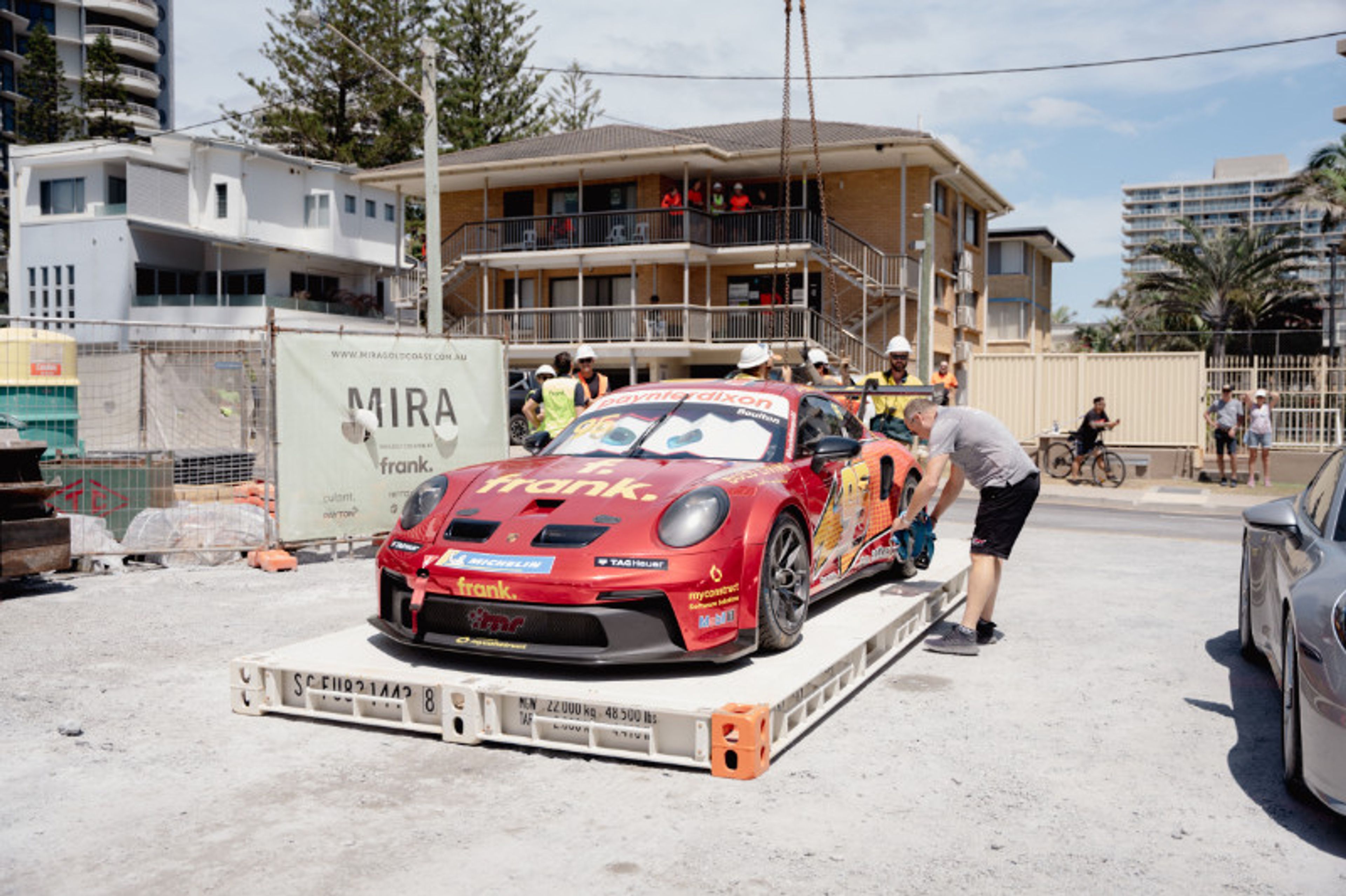 Crew members prepare to lift Brett Boulton’s Porsche GT3 Cup car at Frank Developments’ MIRA site on Northcliffe Beach.