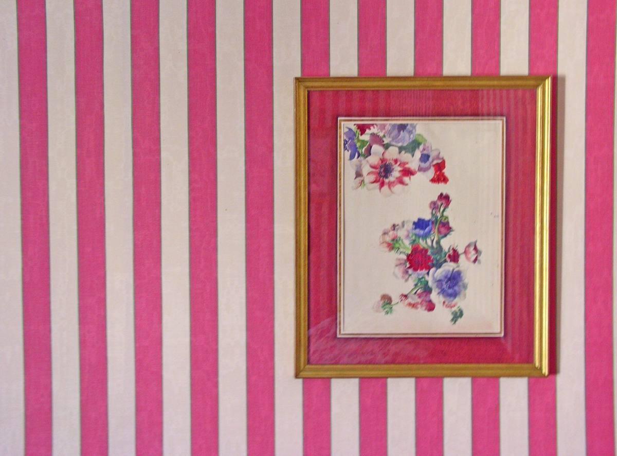 Chambre aux Fleurs: framed floral watercolour on pink-and-white striped wallpaper
