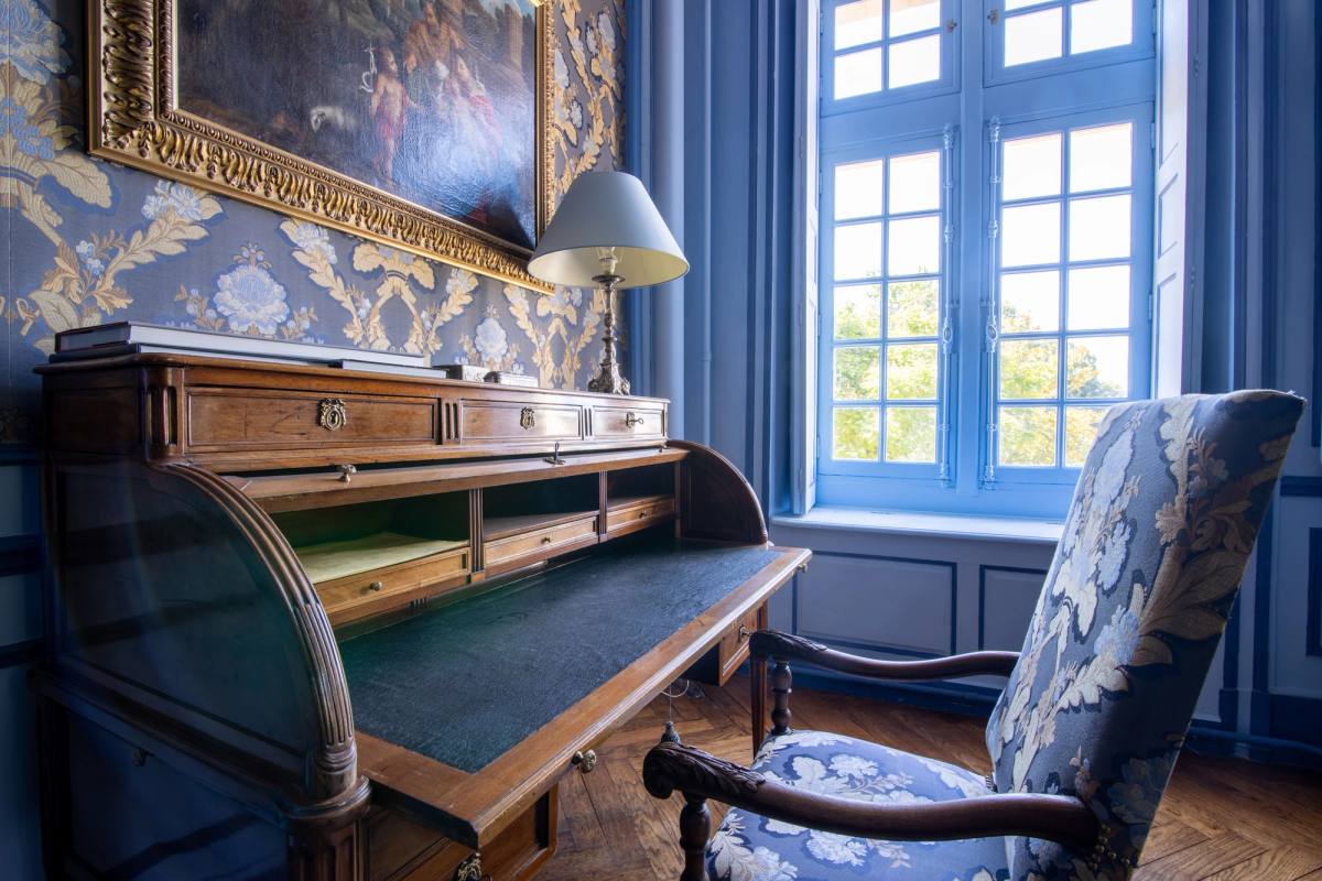 Roll-top desk and damask armchair by a tall window, Chambre Marin de Vanssay