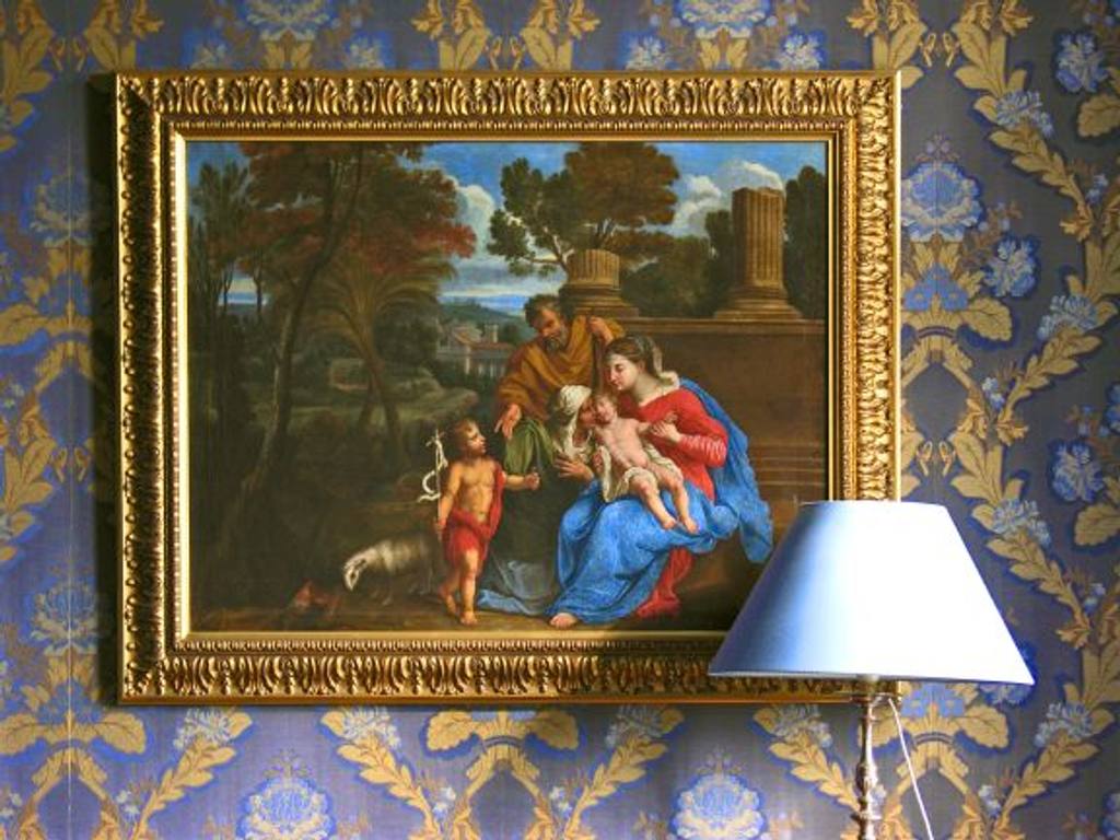Gilt-framed painting of the Holy Family with the infant Saint John and a lamb, on blue and gold damask