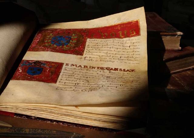 Illuminated armorial manuscript open at painted coats of arms, with the name Marin de Vanssay