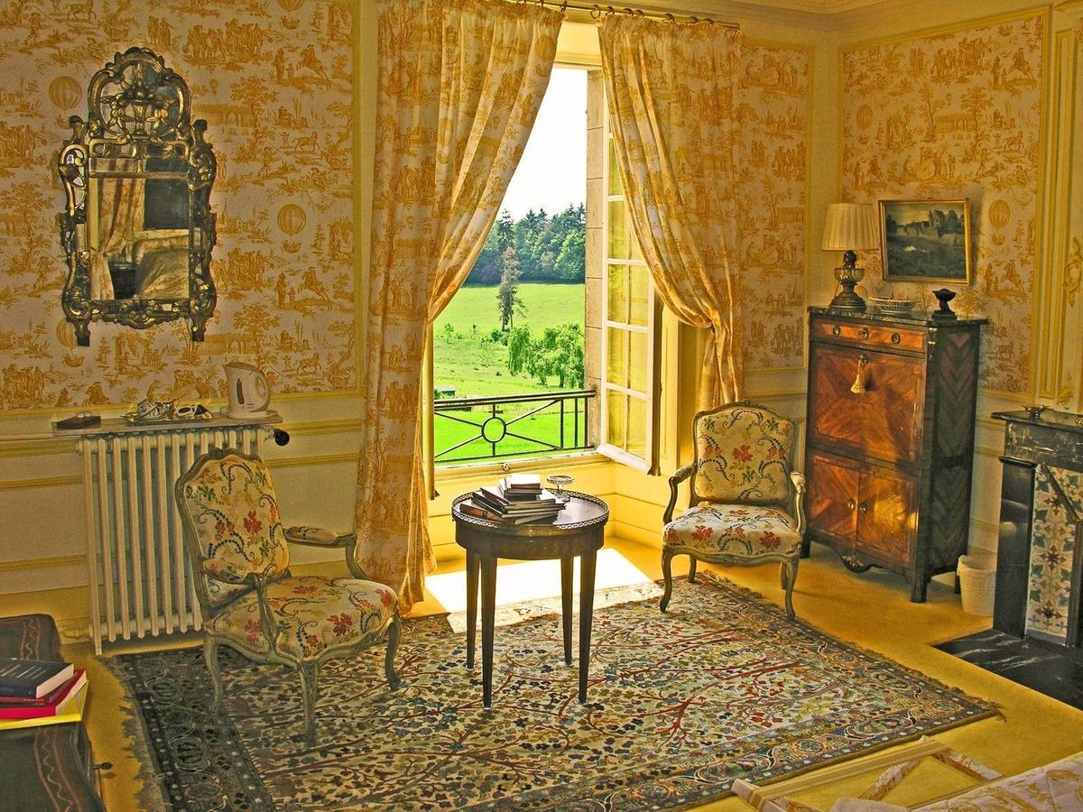 Chambre Jaune: armchairs and a small table before an open window overlooking the park
