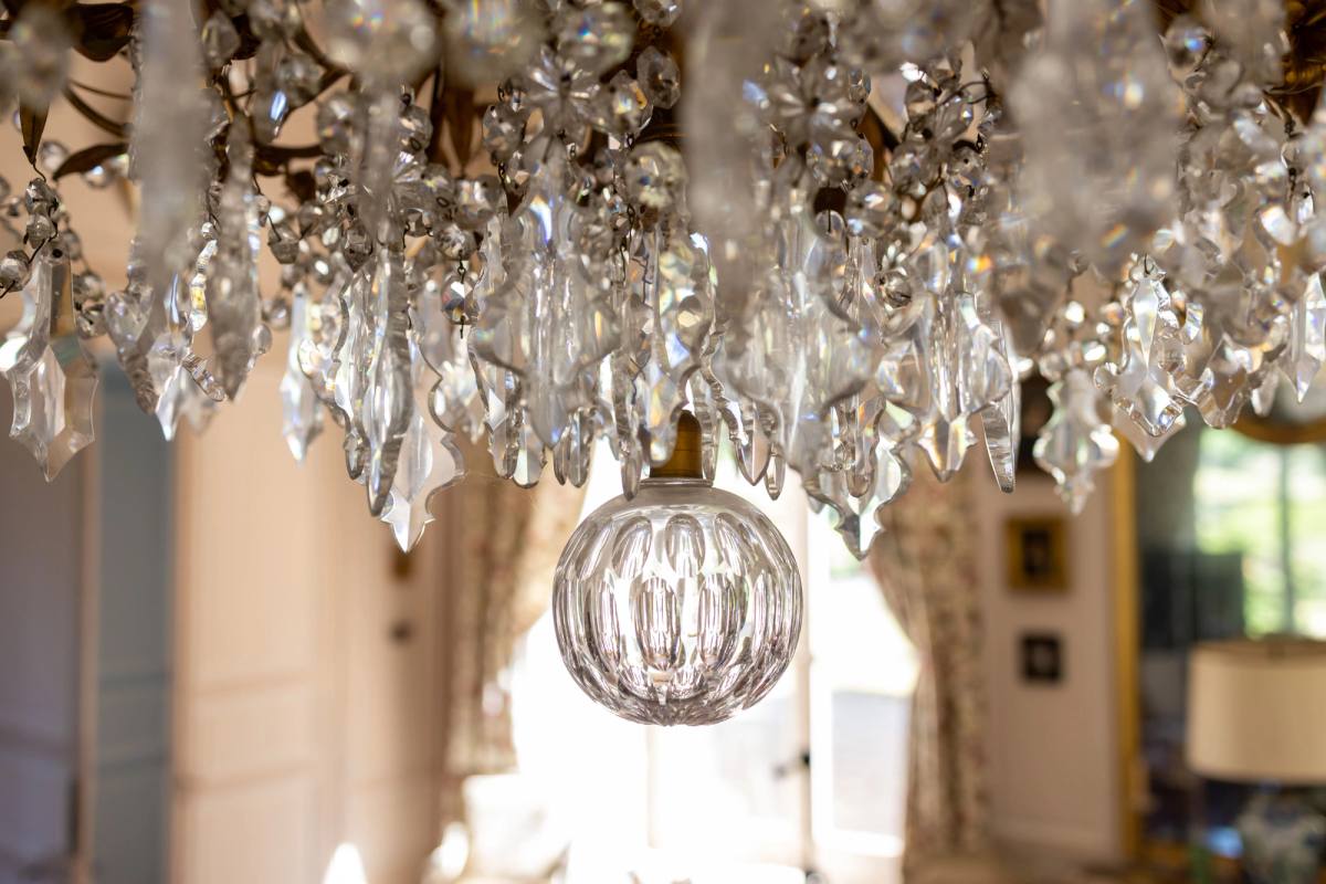 Close-up of the Grand Salon's crystal chandelier with cut-glass pendants and globe