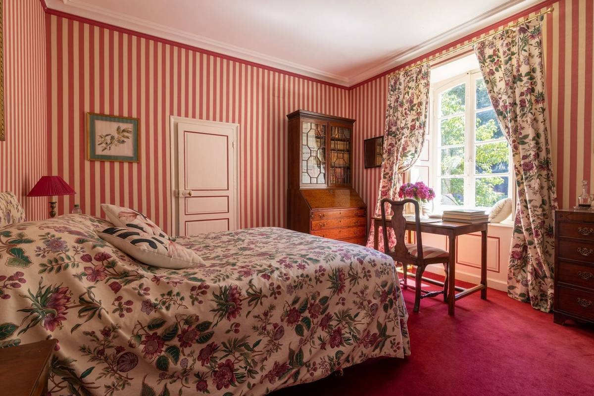 Chambre aux Fleurs: floral bed, striped walls, secretary bookcase and desk by the garden window