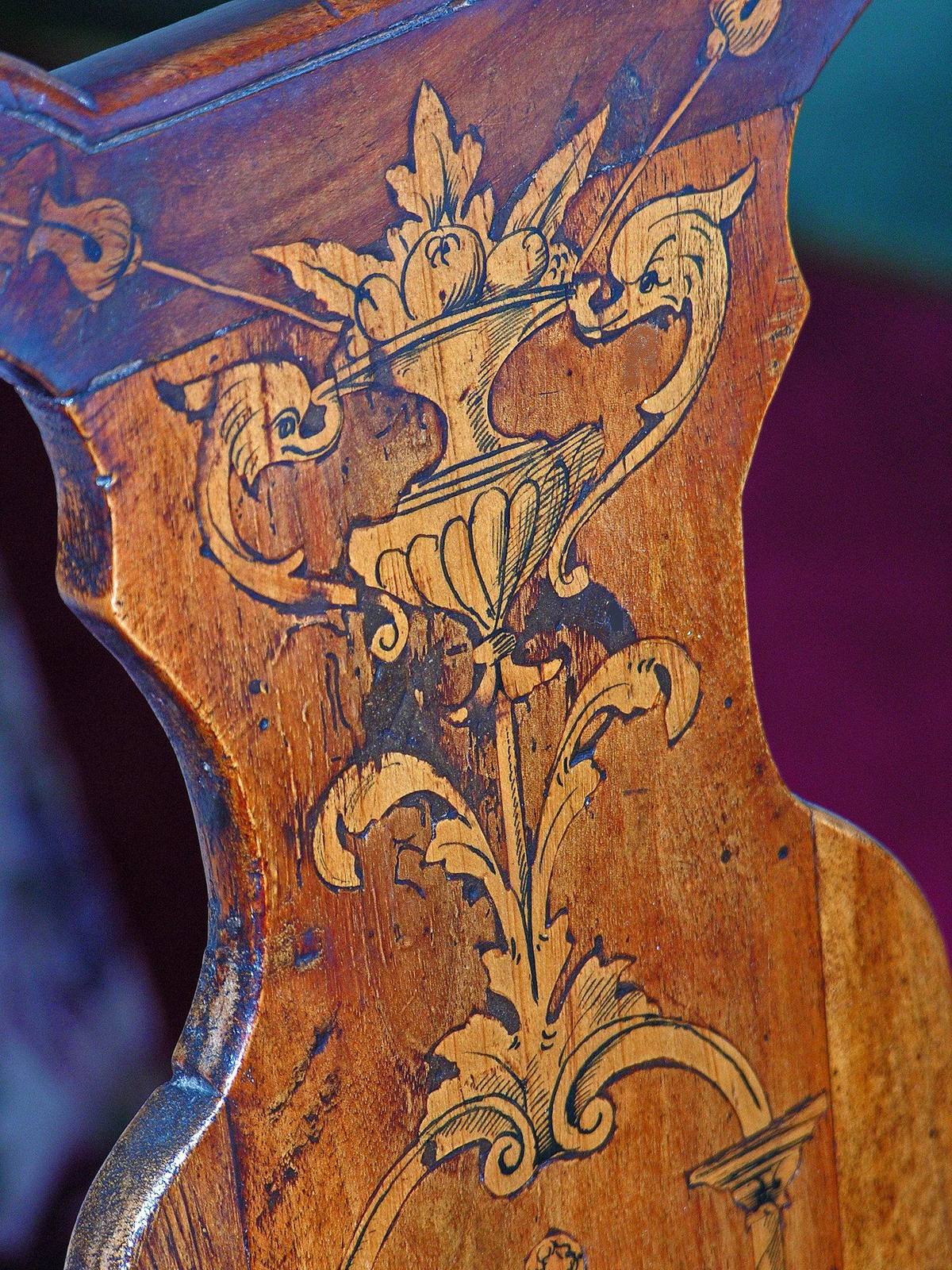 Detail of inlaid marquetry on a Dutch chair back: urn of fruit and foliate scrolls