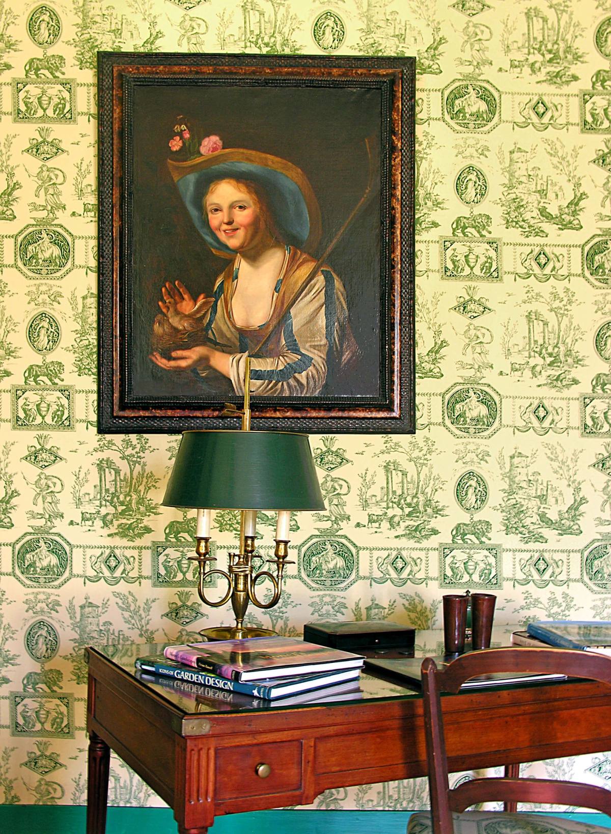 Portrait of a smiling girl in a straw hat above a desk with a bouillotte lamp, Chambre Esprit de Jouy Verte