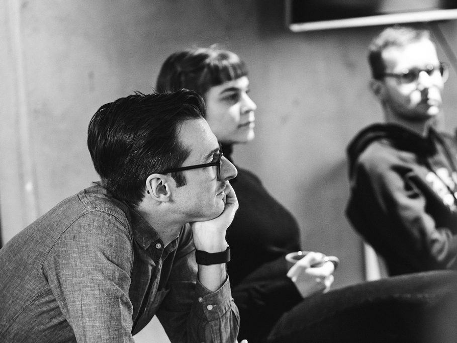 Dienstleister & Kunde bilden ein gemeinsames individuelles Entwicklungsteam Drei Kolleg:innen aus der Softwareentwicklung vertieft in einer Teambesprechung