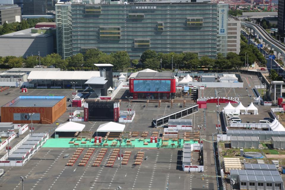 Pavilion exterior — aerial or approach view showing LED visor and surrounding Olympic precinct
