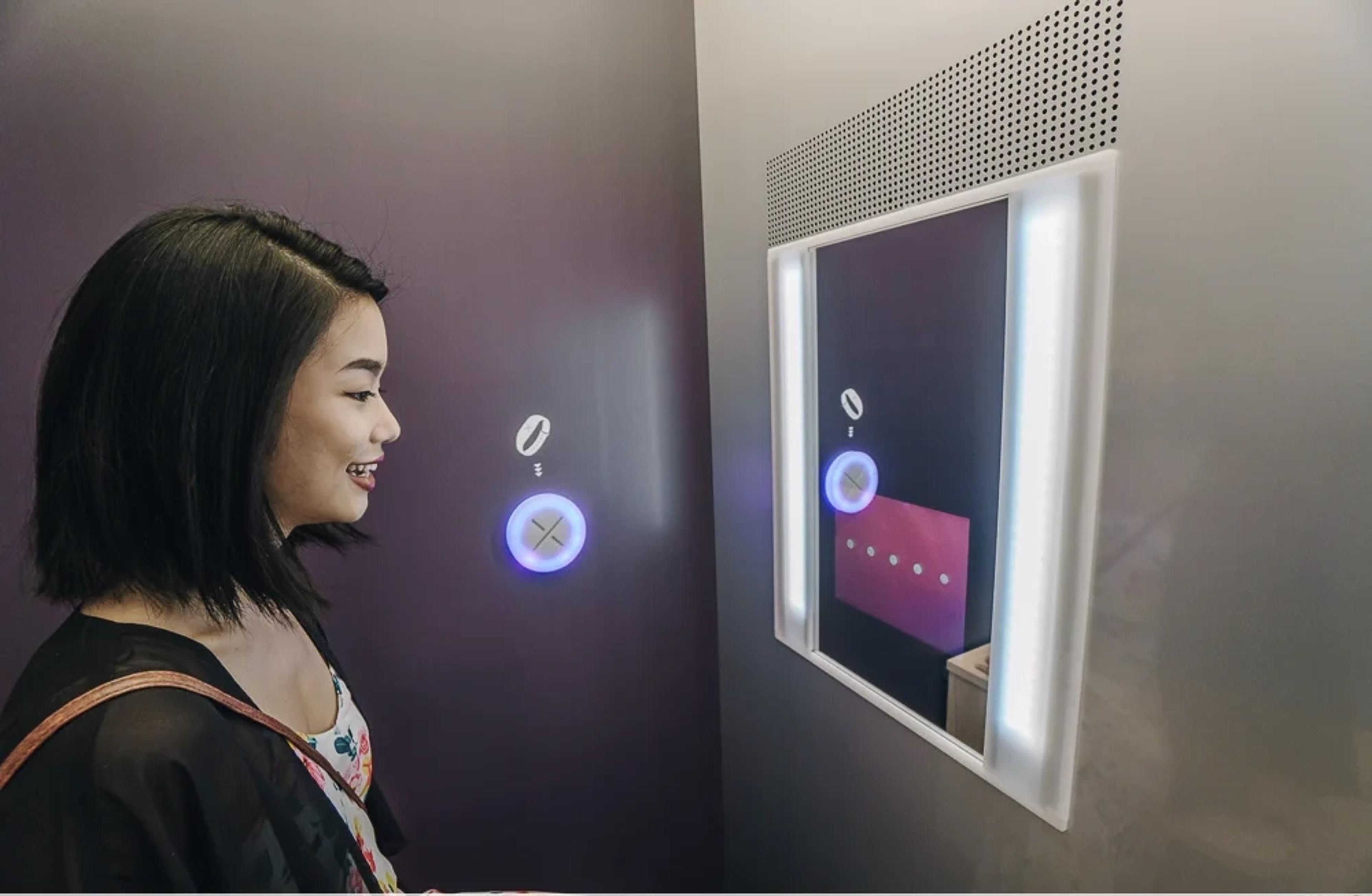 Skin analysis booth - guest receiving personalized results on interactive wall