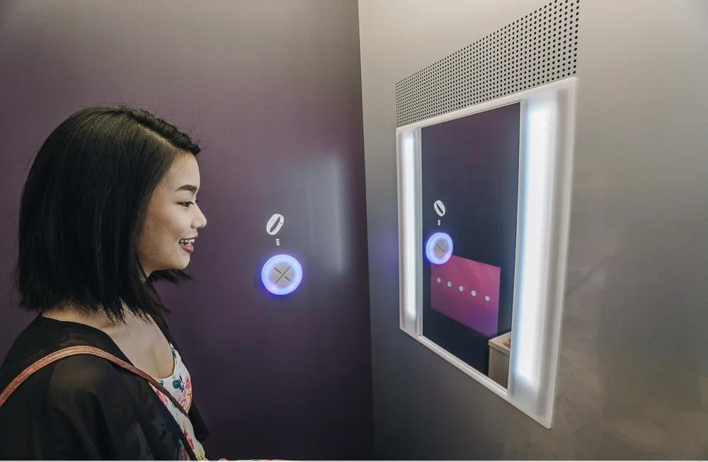Skin analysis booth - guest receiving personalized results on interactive wall