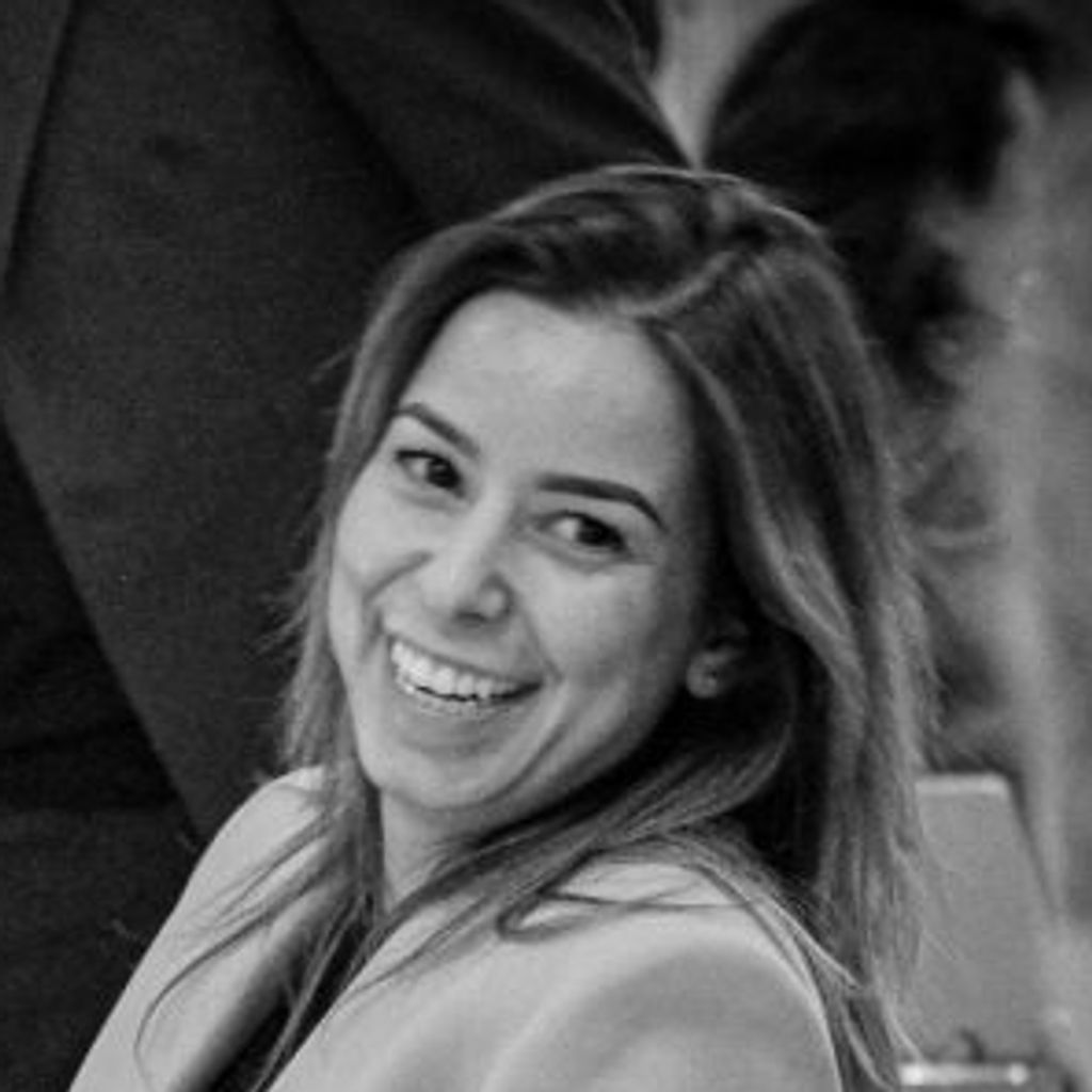 Woman smiling at a dinner table
