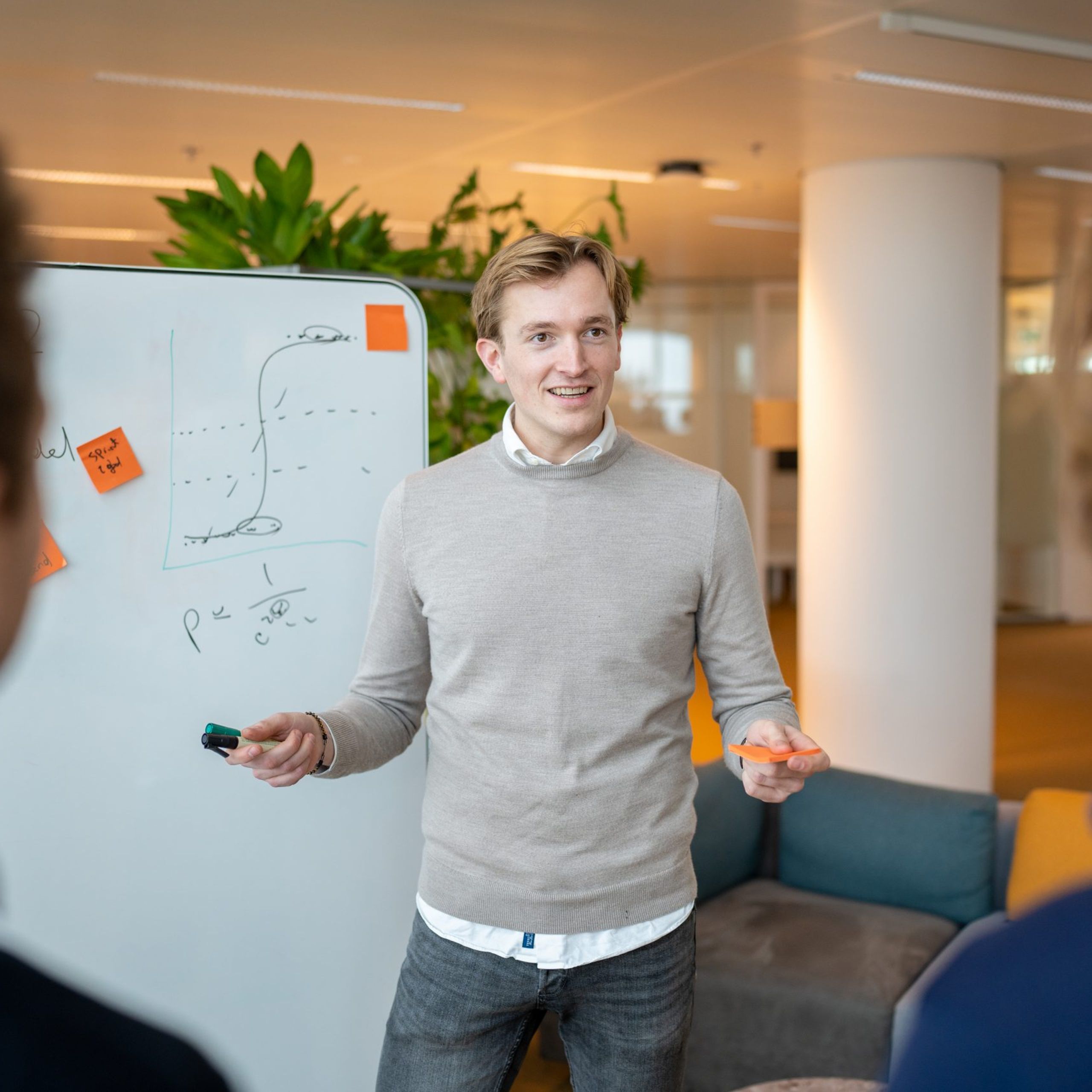 Michiel presents something in front of a white board