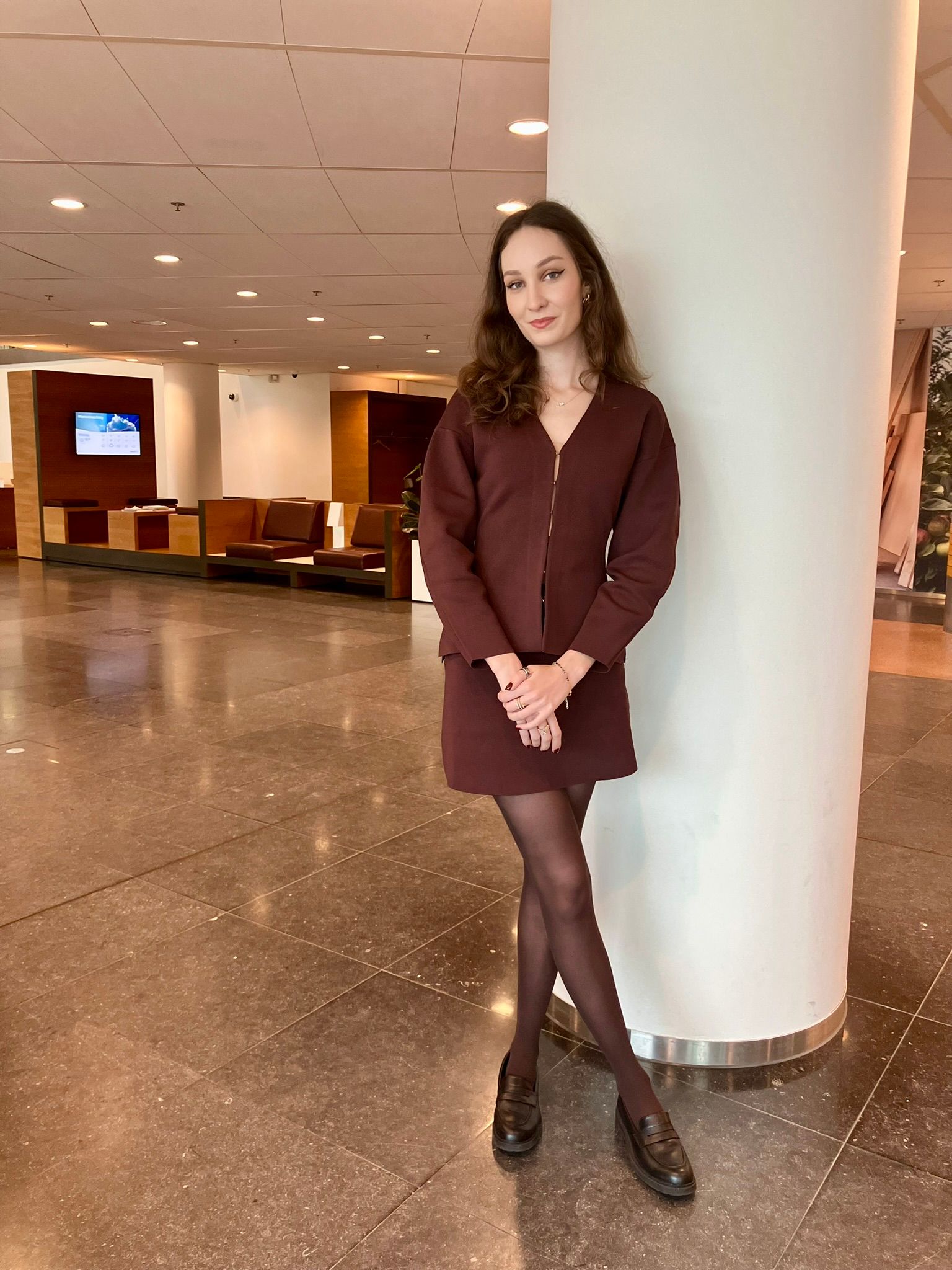 woman wearing a burgundy skirt and cardigan