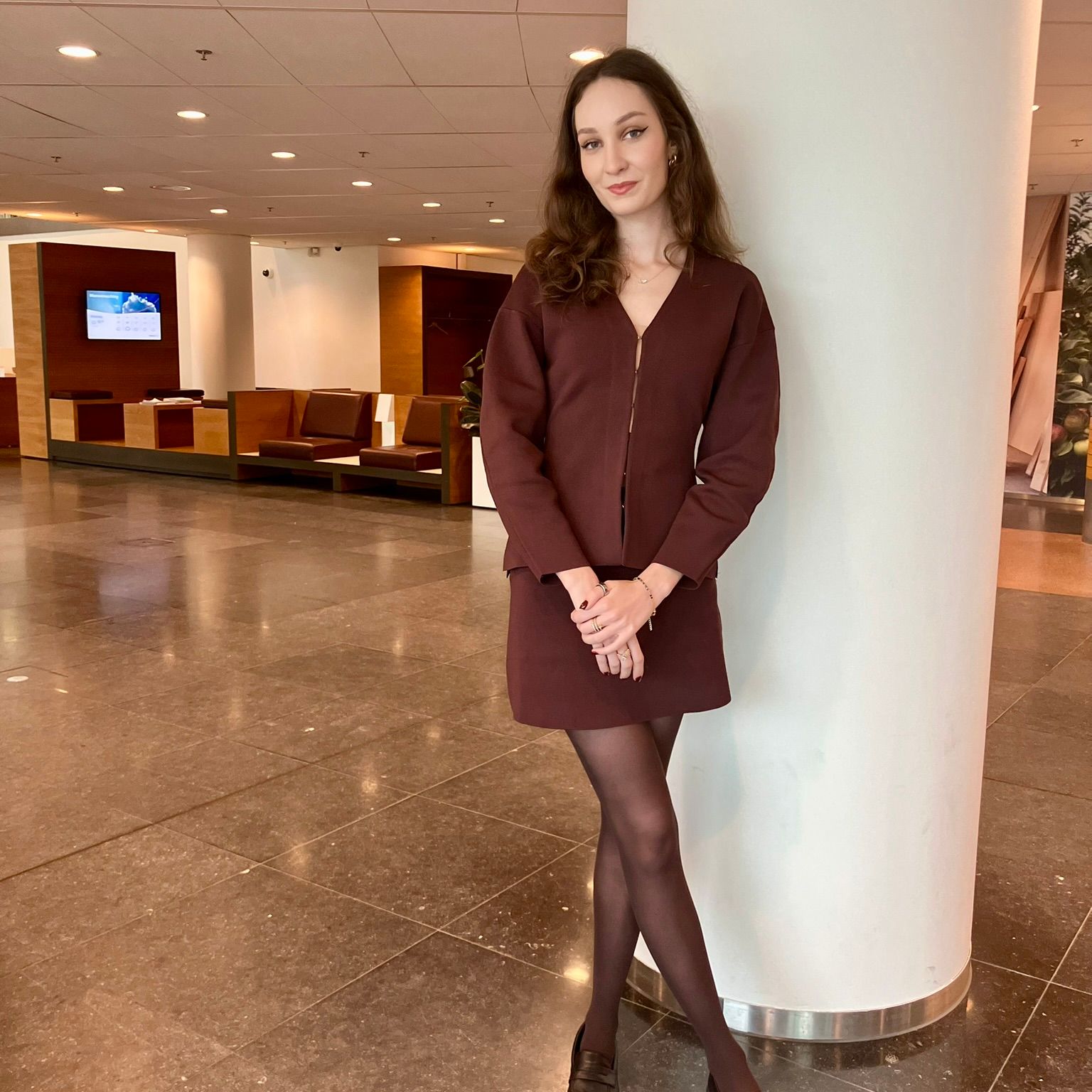 woman wearing a burgundy skirt and cardigan