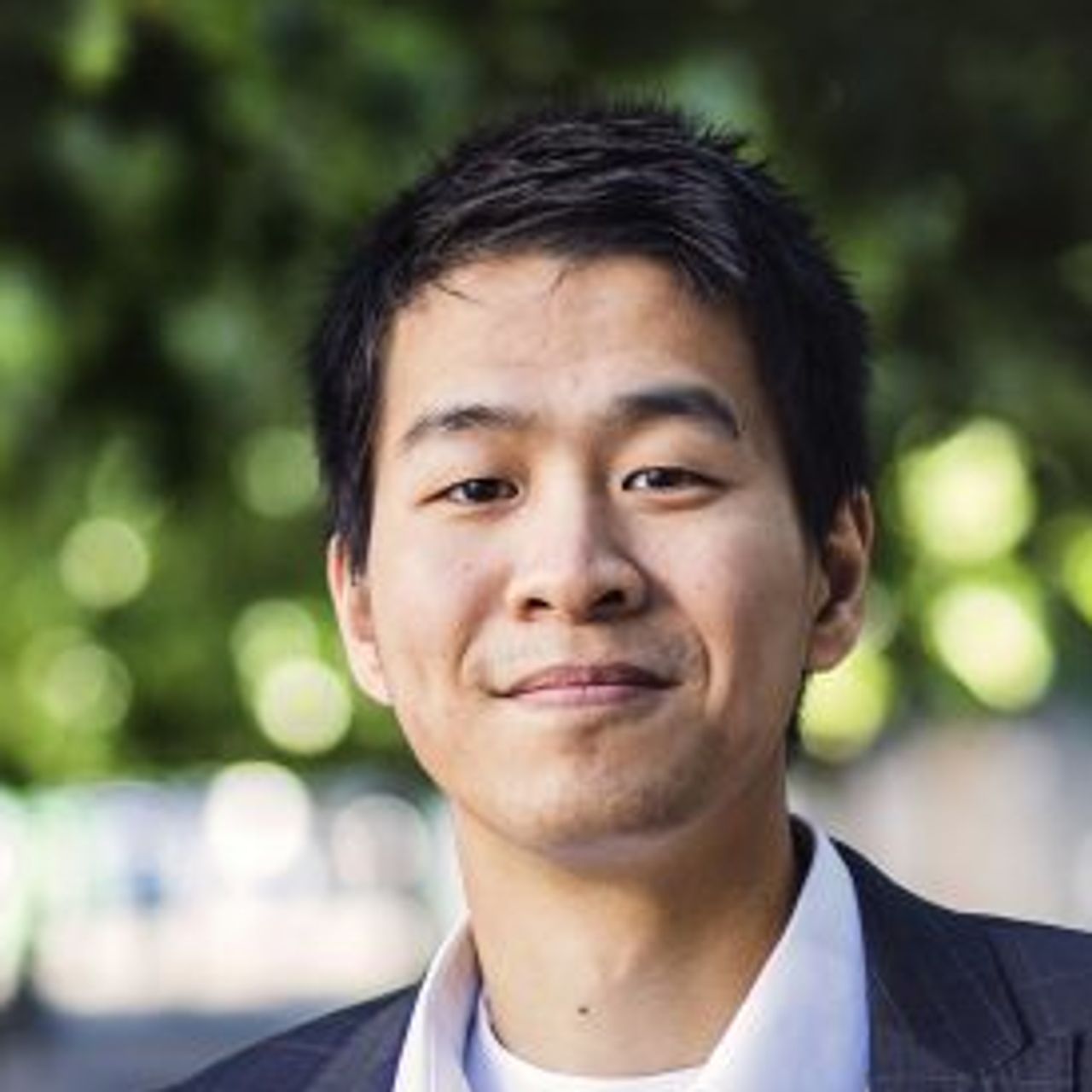 Asian man in suite in park