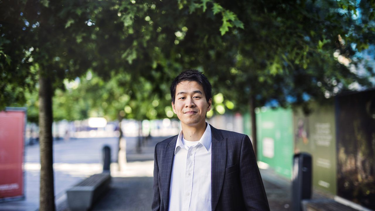 Asian man in suite in park