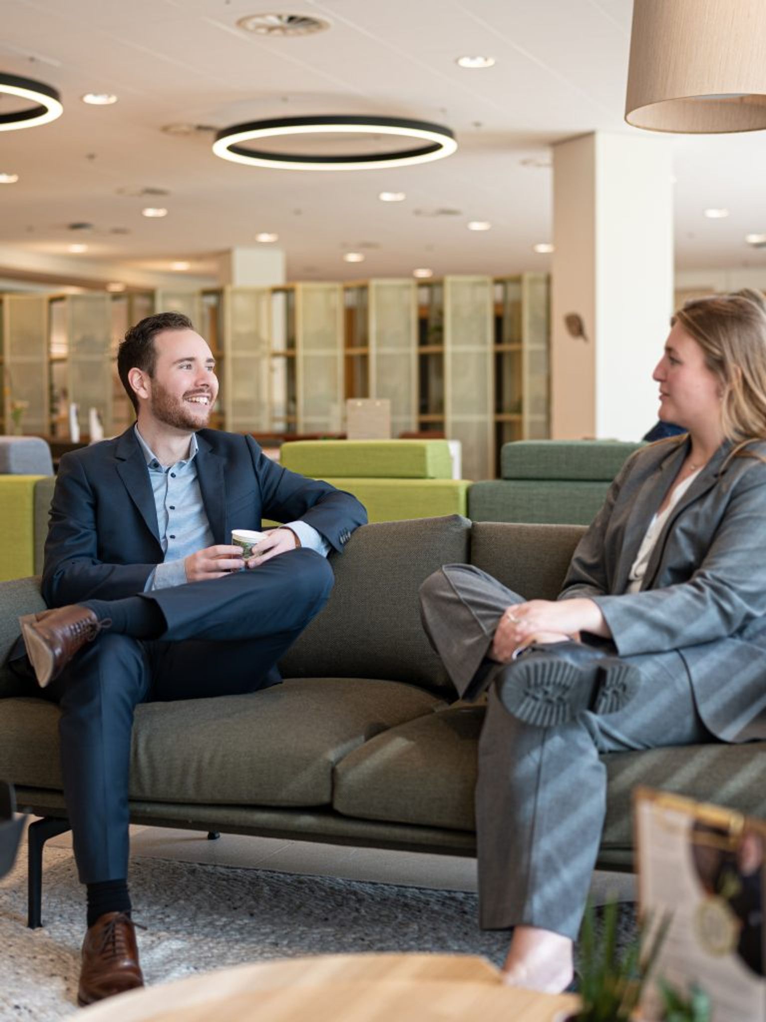 Alec Bakker on a sofa with a colleague