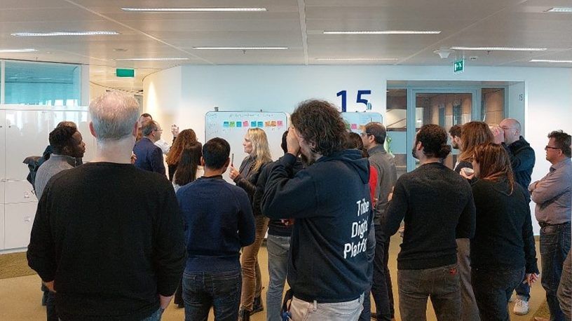 Attendees gathering around the white board