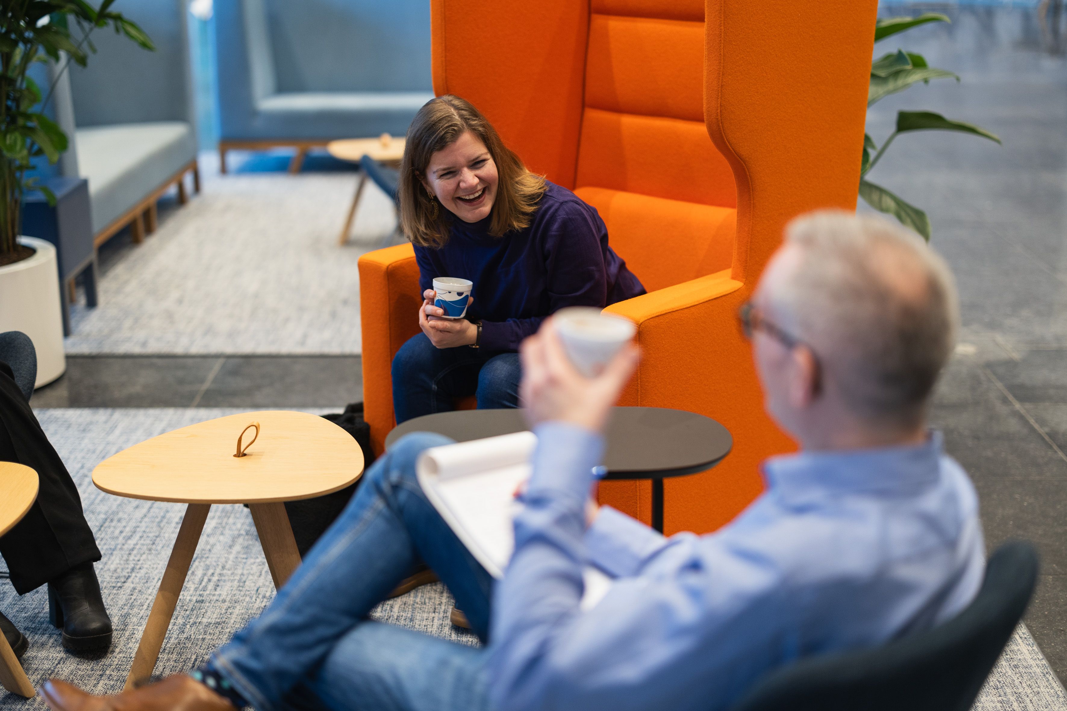 Two colleagues lauging at the office