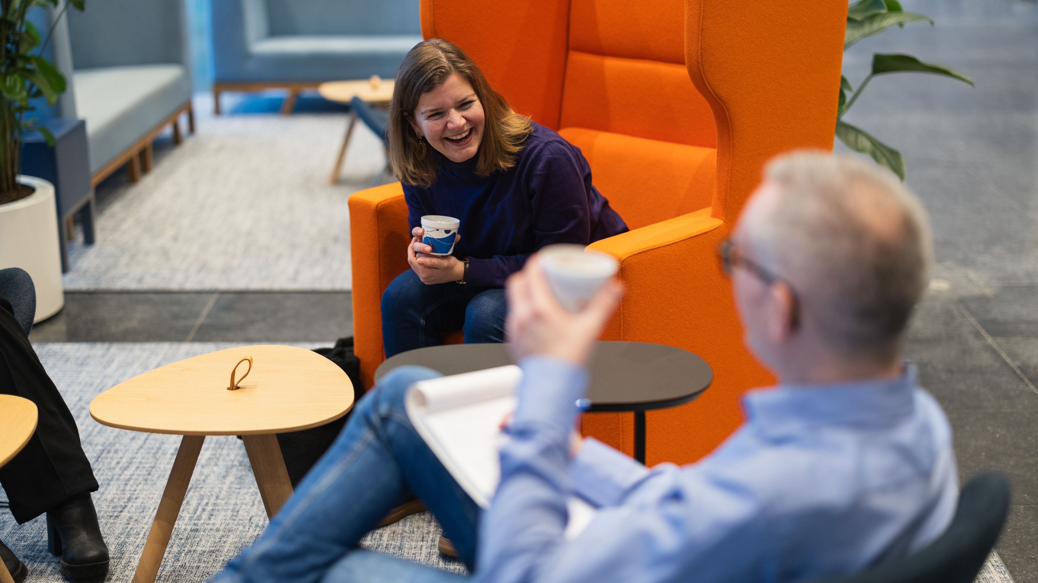 Two colleagues lauging at the office