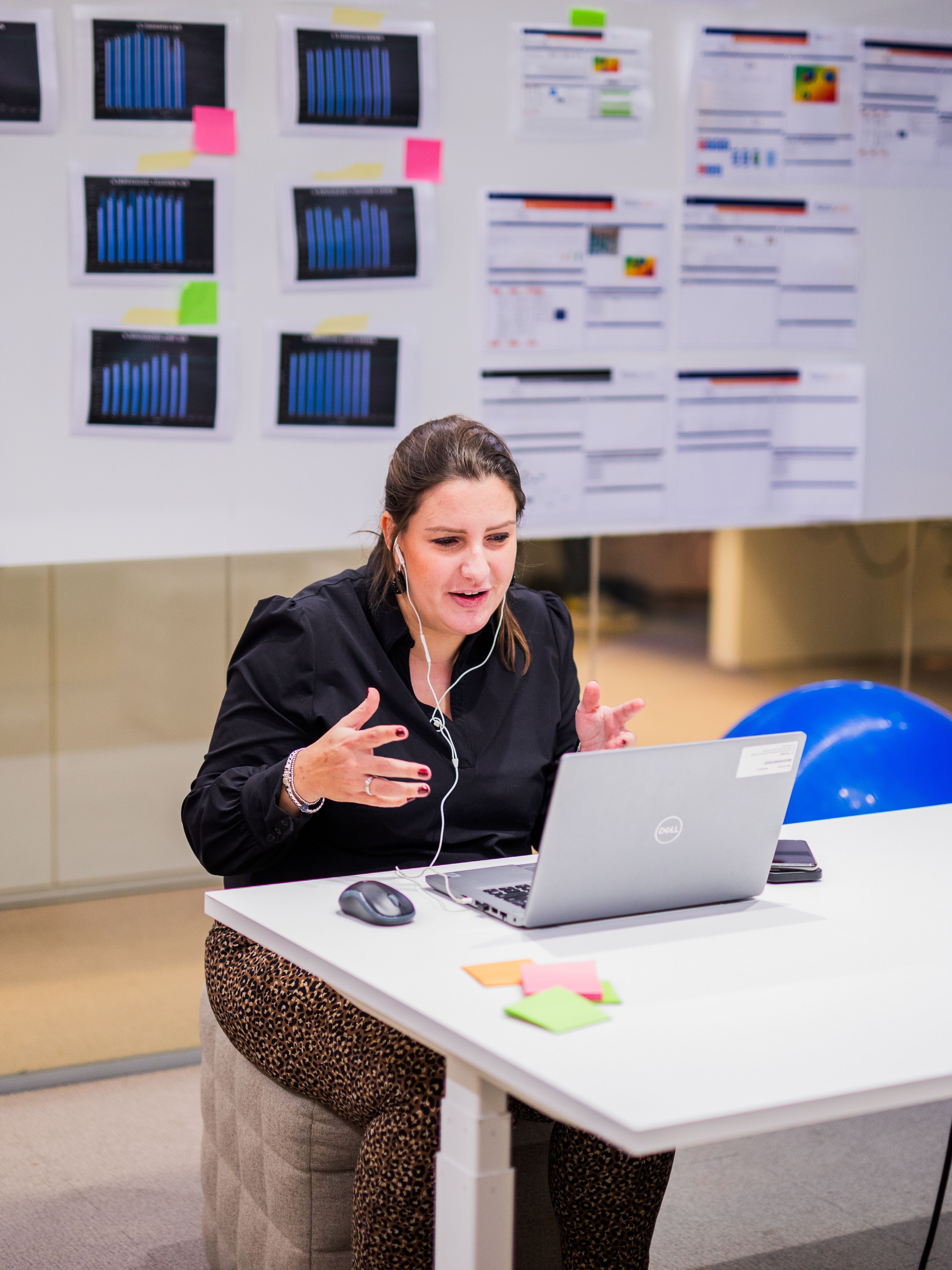 Woman sitting behind laptop.