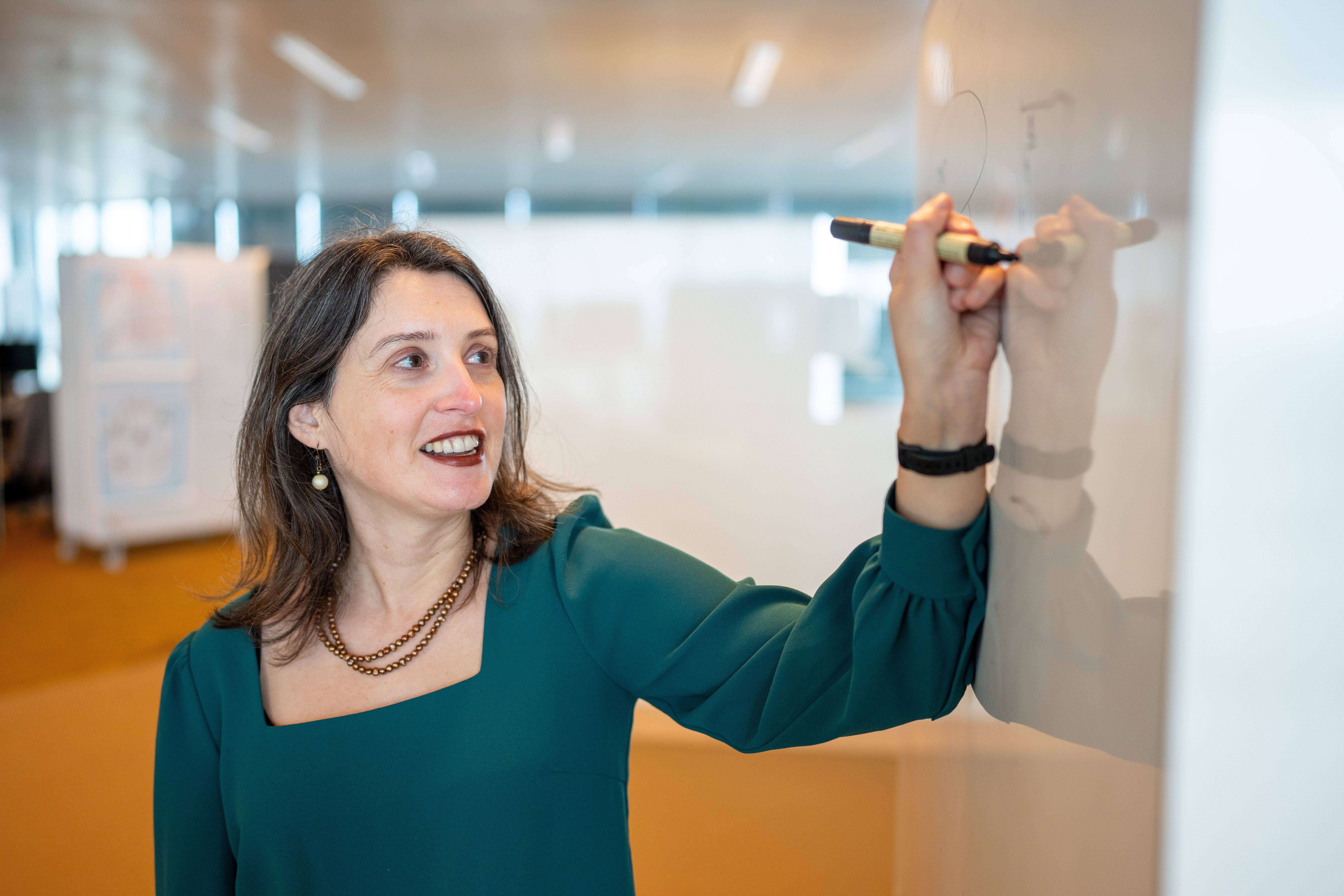 woman writing on a whiteboard