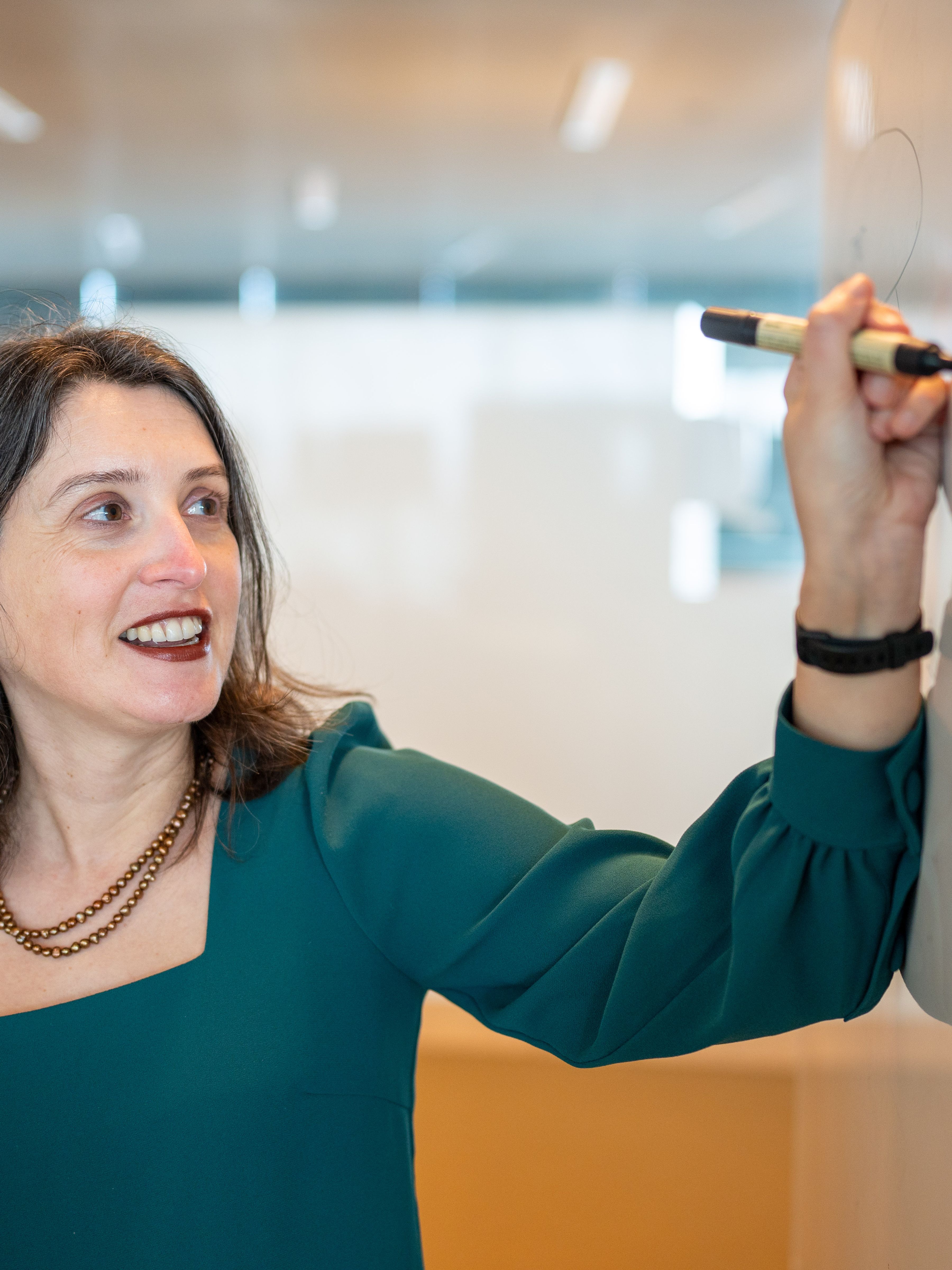 woman writing on a whiteboard